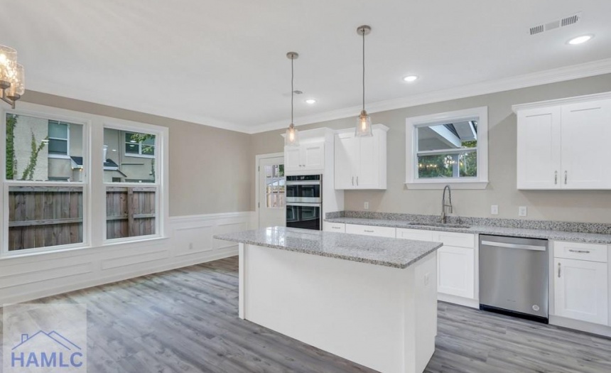 Open Concept Kitchen with an Island & Granite Coun