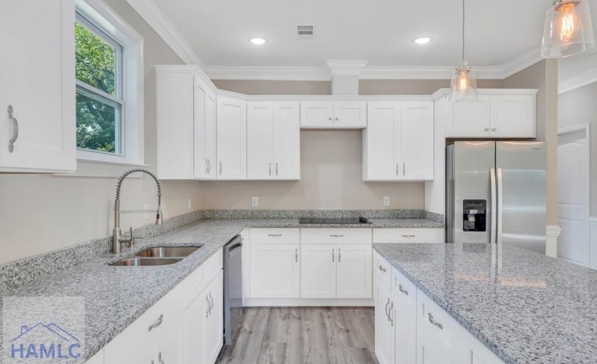 Open Concept Kitchen with an Island & Granite Coun