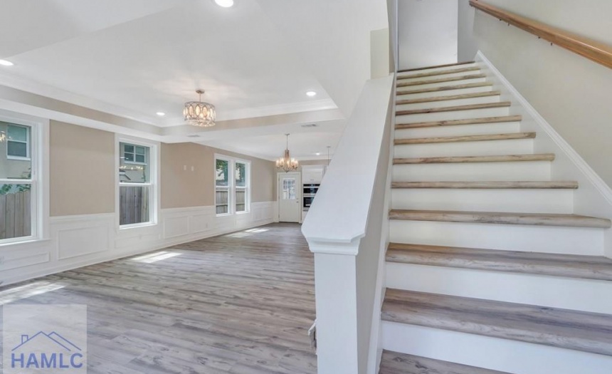 Open concept living/dining room area with crown mo