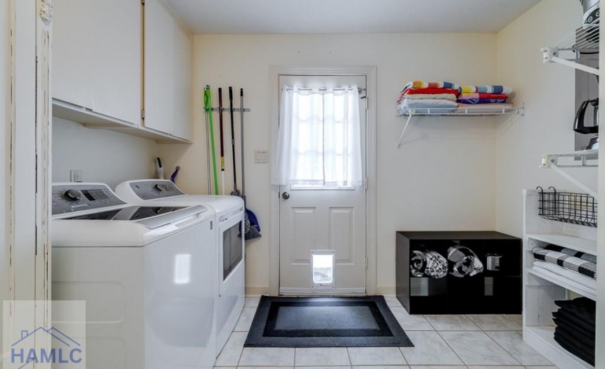 Laundry with storage; door to backyard